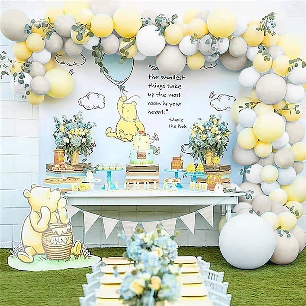 Gender-neutral honey bear balloon garland party box for a Winnie the Pooh baby shower.