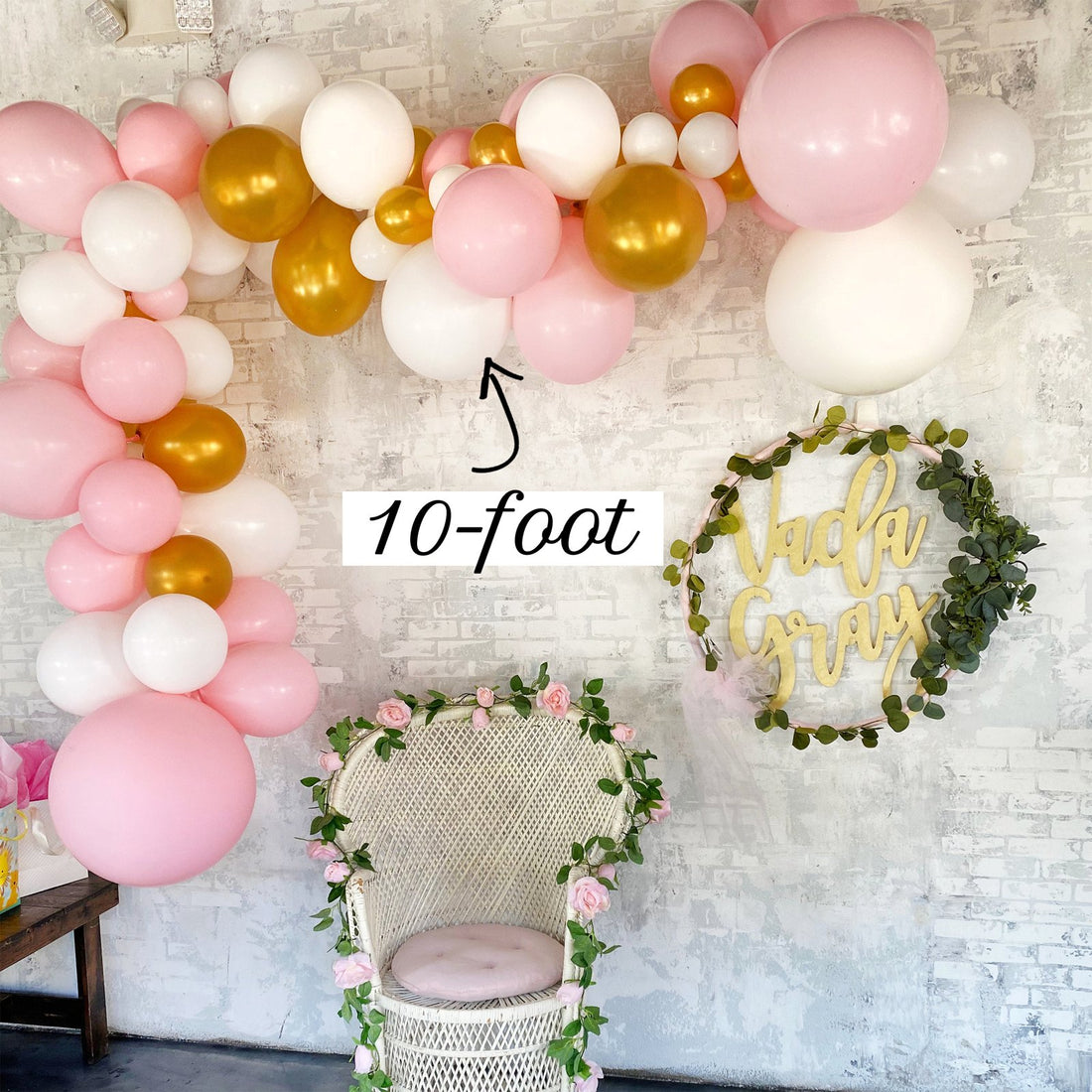 10ft pink, white and gold balloon garland along a white brick wall, labeled 10-foot